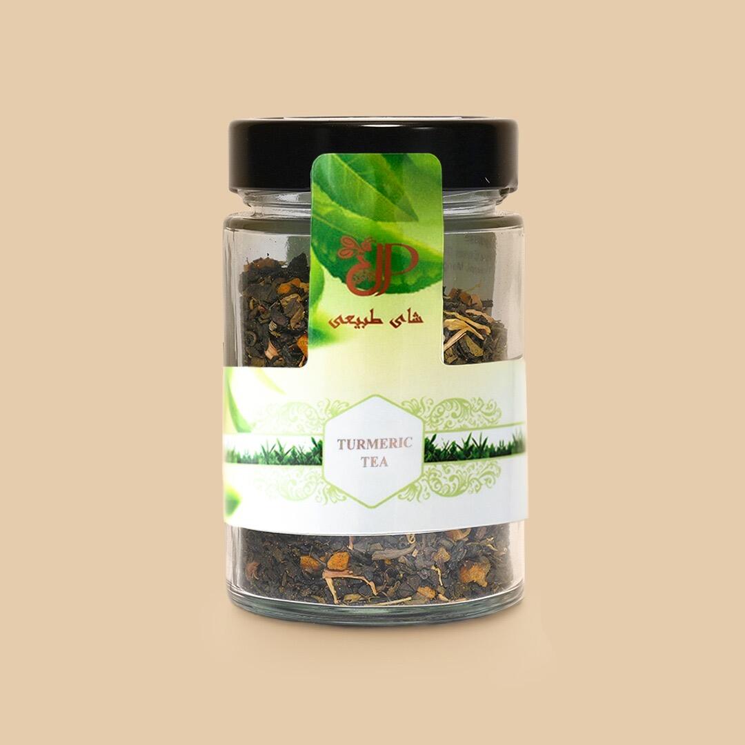 Clear glass jar with black lid containing Turmeric Royal Tea leaves and root pieces, featuring a label with green graphics and Turmeric Tea text on solid backgr